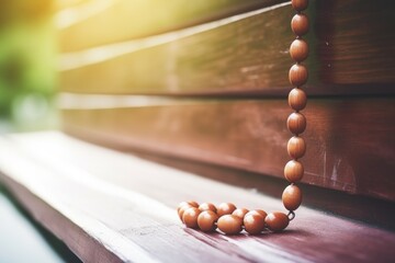 close-up of a rosary on a church wooden pew