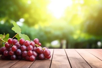 Zelfklevend Fotobehang grapes on the wooden table with vineyard background © Muhammad Hammad Zia