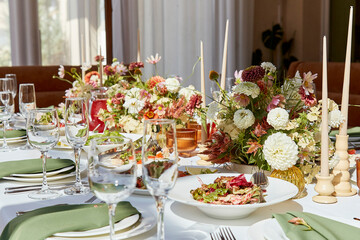 Elegant summer table setting with candles and flowers design. Restaurant chamber event in provence style