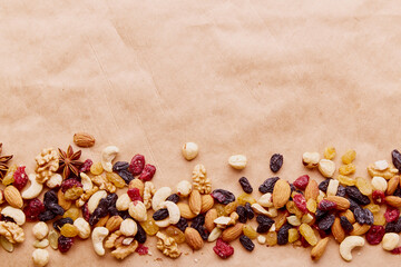 Aesthetics assorted nuts mix in line with copy space. Walnuts, almonds, hazelnuts and cashews, raisins and cranberries. Healthy food and snacks.