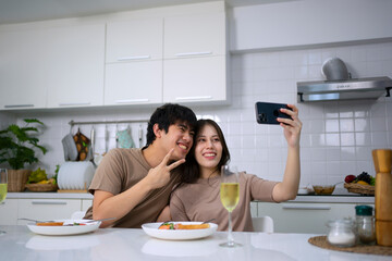 Young couple is shopping online in kitchen.