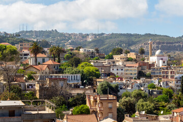 Fototapeta na wymiar Algiers, Alger, Algeria, 04 10 2023 : Panoramic view of the northern districts of Algiers. Houses, mosque, green hill.