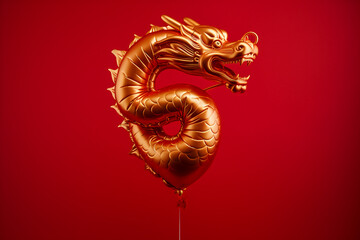 Chinese new year party: Gold Chinese zodiac dragon shape foil balloon on a red background for year 2024