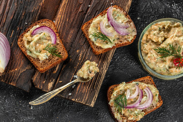 Delicious sandwiches with lard spread on a wooden board. banner, menu, recipe place for text, top view