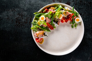 Salad nicoise. Tuna, with green beans, tomatoes, potatoes and a vinaigrette mustard dressing in white plate