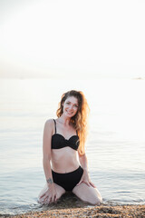 Fototapeta na wymiar woman in black swimsuit on the beach leisure walk travel