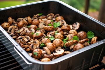 closed grill container filled with grilling mushrooms - Powered by Adobe