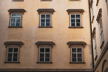 Fototapeta na wymiar Vintage yellow building with various windows in Vienna, Austria
