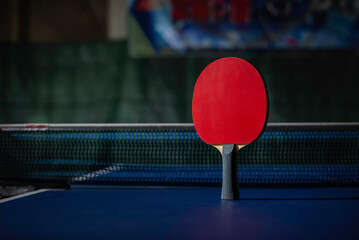 table tennis racket On the blue ping pong table