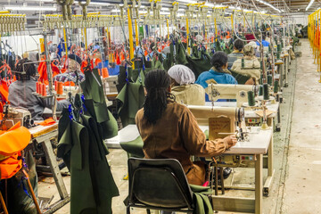 african woman factory workers in the textile industry working on workwear clothing