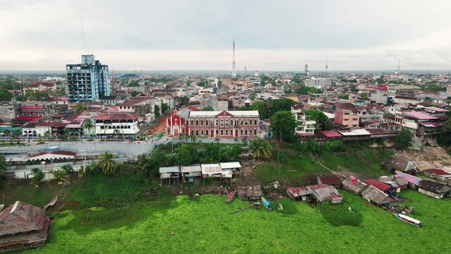 Aerial view of the floating houses on Itaya river and Malecon Tarapaca Boulevard in Iquitos, Peru