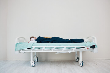 Doctor, sleeping and break on hospital bed, tired and burnout from healthcare service, overworked...