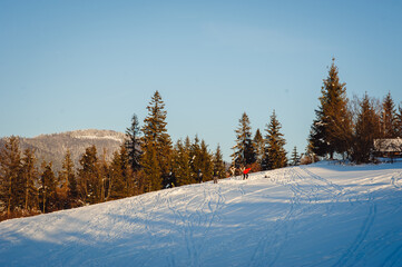 Skiers stopped to rest on the slope. Mountain track for skiers.