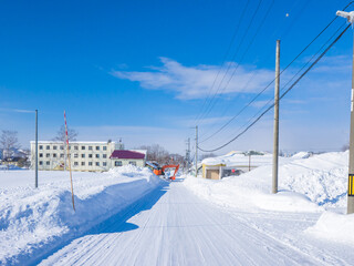 Excavator removing snow in a town with heavy snowfall (Niseko, Hokkaido, Japan)