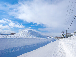 Snowplowed road and snow piled up on the side (Niseko, Hokkaido, Japan)
