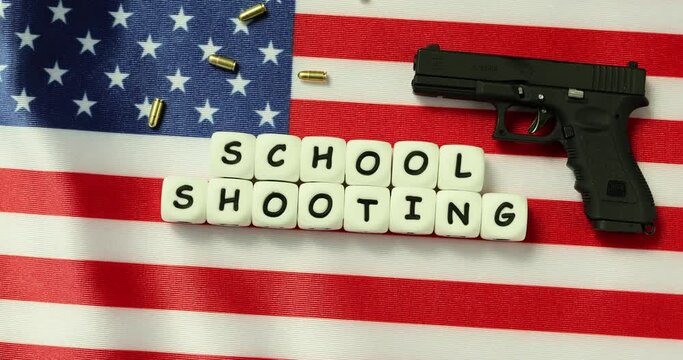 Word school shooting from gun and bullets. American flag with automatic pistol