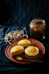 Lemon tartlets on a black background. An exquisite European dessert with fruit filling.