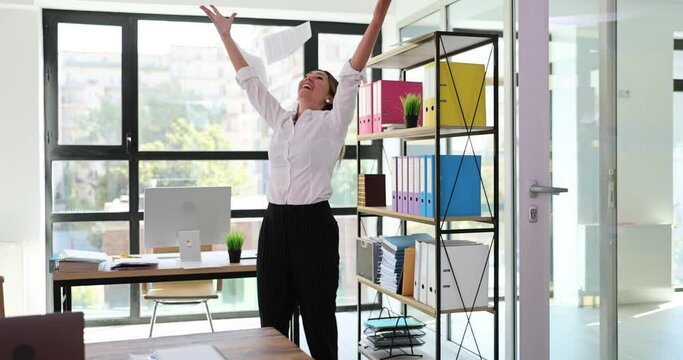 Delighted woman manager experiences euphoria and reads good news and throws papers. Happy excited young woman triumphant and receives amazing message in mail documents or correspondence