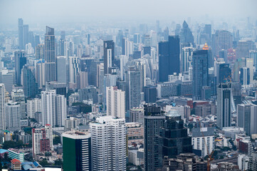 Fototapeta na wymiar Bangkok cityscapes, skyline, high rise office buildings and skyscrapers in Bangkok city, winter daylight, top view behind pollution haze or PM 2.5 in winter season, Bangkok, Thailand