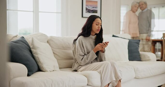 Sad, woman and grief in a home with mourning and ghost of senior parents with memory in living room. Depression, loss and lounge with stress and upset female person thinking about death and dying