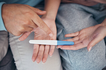 Obraz premium Hands, couple and closeup of pregnancy test, results and waiting for news together in home. Top view, kit and pregnant woman and man family planning for future maternity, ivf fertility and support