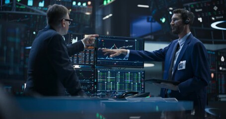 Two Successful Traders Analyzing Real-Time Financial Data and Reports About the State of the Finance Market. Stock Exchange Professionals Discussing Buy and Sell Options For Different Bonds