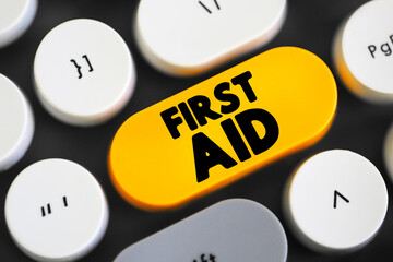 First Aid is the first and immediate assistance given to any person suffering from either a minor or serious illness or injury, text concept button on keyboard - obrazy, fototapety, plakaty