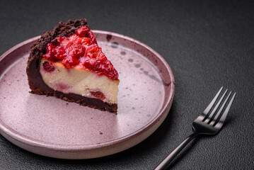 Beautiful tasty sweet slice of cheesecake with cherry on a ceramic plate