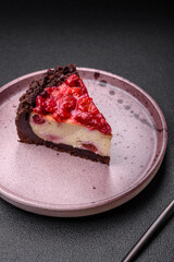 Beautiful tasty sweet slice of cheesecake with cherry on a ceramic plate