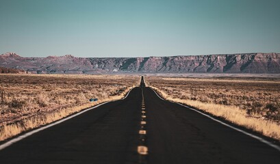 Scenic view of an empty asphalt road in a barren desert