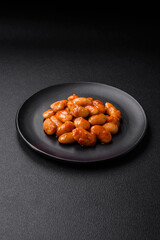 Delicious canned beans in a tomato in a round ceramic plate