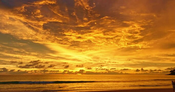 .aerial view amazing yellow cloud on sky in sunset above Karon beach Phuket..Scene of Colorful romantic sky sunset with Changing the color of the sky background..light rays and atmospheric effects