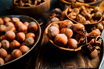 Nuts background. Freshly harvested hazelnut. On a black stone background.