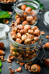 Organic shelled hazelnuts in a glass jar. Nut kernels. Close up.