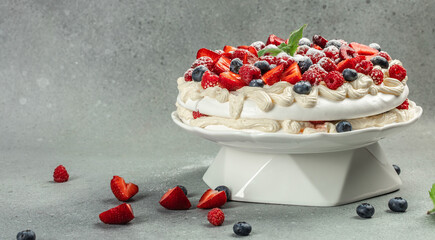 delicious meringue cake, Unfinished pavlova cake. Meringue with topping with whipped cream and strawberries. culinary, bakery, food and people concept