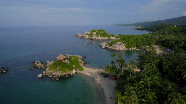 Drone ascent revealing Cabo de San Juan coastline in Tayrona National park of Colombia