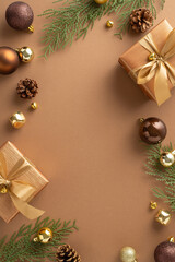 Vertical top view elegant holiday arrangements featuring opulent gift boxes, baubles, delicate jingle bells, spruce twigs with cones on brown backdrop. Perfect for festive greetings and advertisements