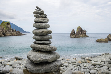 Pebble tower balance harmony stones over the stone beach