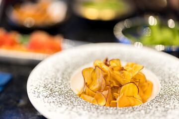 Slice of crispy sweet potato in dish at restaurant