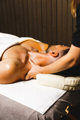 A man relaxes in a massage room for a facial massage. The concept of health and skin care