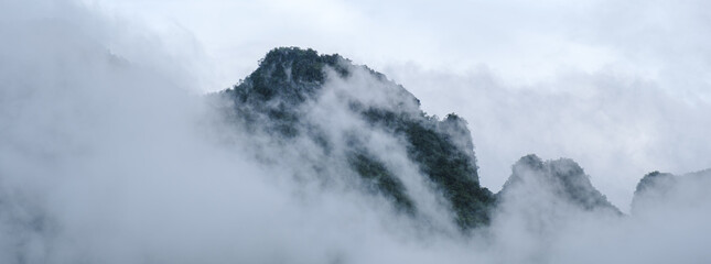 Mountain peak with fog and mist at Doi Luang Chiang Dao mountain hills in Chiang Mai, Thailand. Nature landscape in travel trips and vacations. Doi Lhung Chiang Dao Viewpoint with mist and fog 