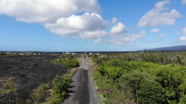 The road into kalapana lava rock community with jungle and cooled lava