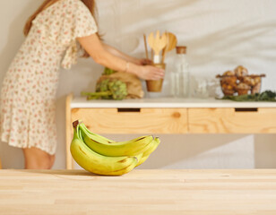 Banana on the wooden table and kitchen background style. Woman background.