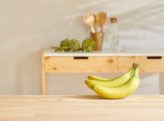 Banana on the wooden table and kitchen background style.
