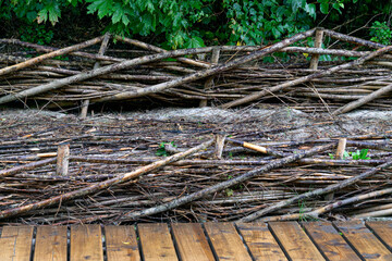 Layers of willow branches between wooden posts provide protection from wind and waves.