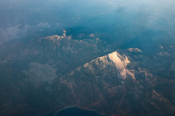 Panoramic view from airplane window of mountain landscape in Cyprus at dawn - 661410312