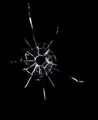 Fototapeta premium Cracked texture of broken glass on a black background.