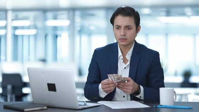 Upset Indian businessman counting money