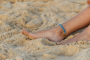closeup shot of feet showing jewelry such as bracelets