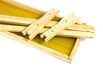 New apiary frame with wax on a white background. Beekeeping equipment for working with beehives
